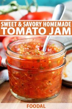 a jar filled with tomato jam sitting on top of a wooden table