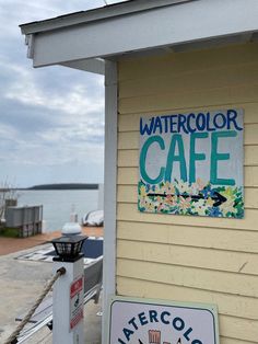 a sign on the side of a building that says watercolor cafe and aftercolo