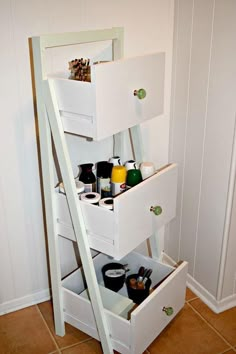 a white shelf with drawers on top of it