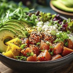 a close up of a bowl of food with avocado, salmon and rice