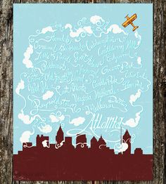 an airplane flying over a city with clouds and words on the side of it,