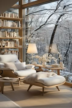 a living room filled with furniture and a large window covered in bookshelves next to a forest