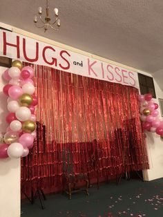 balloons and streamers decorate the entrance to hugs and kisses