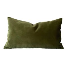 a green velvet pillow on a white background