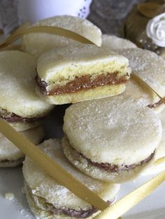 some cookies are stacked on top of each other and tied with a yellow ribbon in front of them