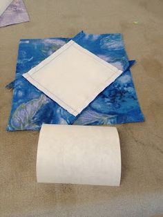 the table is covered with blue and white cloths, napkins, and toilet paper