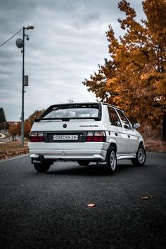 a white car is parked on the street