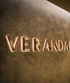 the words veranda are lit up against a wall