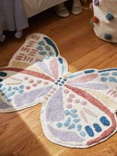 a colorful butterfly shaped rug on the floor