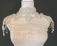 a mannequin with beading and pearls on it