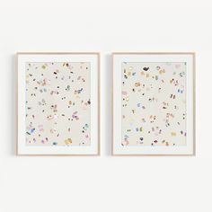 two framed artwork pieces hanging on the wall next to each other, one with sprinkles