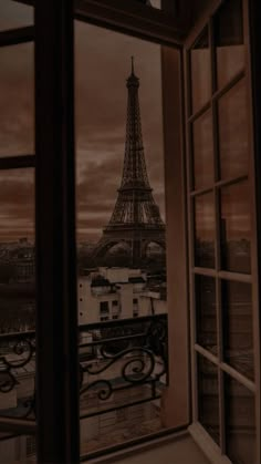 the eiffel tower is seen through an open window