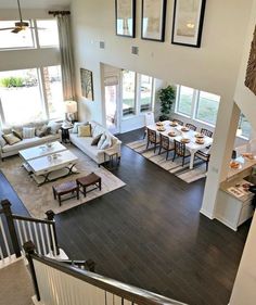 an aerial view of a living room and dining room from the second floor looking down