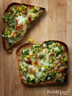 two pieces of bread with broccoli, corn and cheese on them sitting on a cutting board