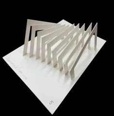 several pieces of white paper stacked on top of each other in the shape of an abstract structure