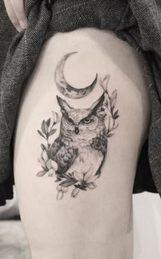 an owl with a crescent moon tattoo on the thigh