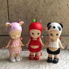 three little dolls are standing next to each other