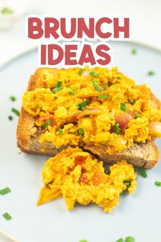 a white plate topped with two pieces of bread covered in scrambled eggs and green onions