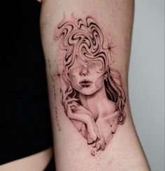 a woman's arm with a black and white tattoo design on the left side