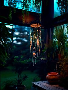 a chandelier hanging from the ceiling in a room filled with potted plants