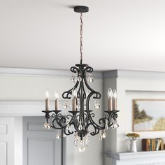 a chandelier hanging from the ceiling in a living room