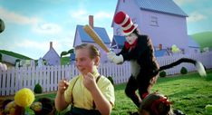 the cat in the hat is holding a baseball bat and posing for a photo with other cats