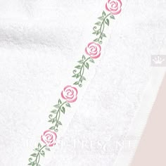 a white towel with pink roses on it