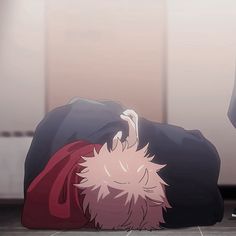 an anime character laying on the ground with his head down and one hand up in front of him