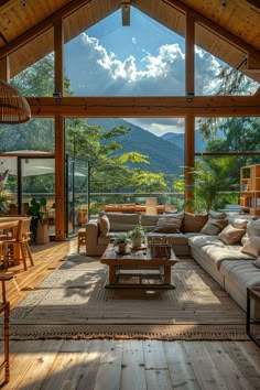 a living room filled with lots of furniture under a large glass window next to a wooden floor