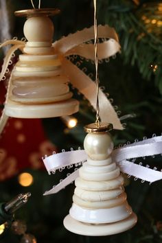 an ornament hanging from a christmas tree decorated with ribbons and ribboned bells