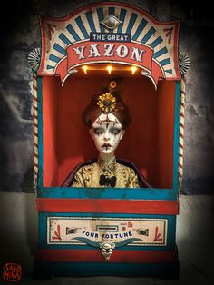 a doll is in a toy machine with lights on it's head and the words, the great yazon