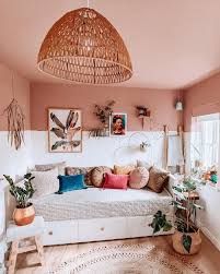 a bed room with a neatly made bed and lots of plants