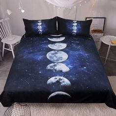 a bed with four phases of the moon on it