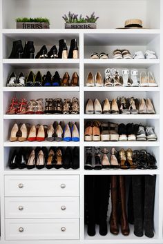 a white closet filled with lots of shoes