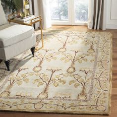 a living room with a couch, chair and large rug on the floor in front of a window