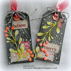 two tags are decorated with berries and leaves