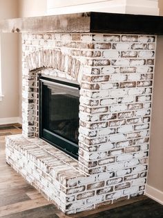 a white brick fireplace in a living room