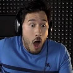 a man wearing headphones making a surprised face