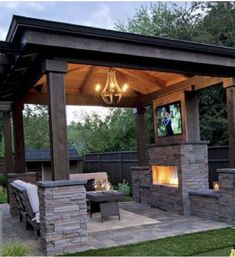 an outdoor living area with fireplace and grill