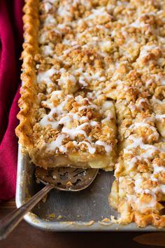 a close up of a pie on a pan with a spoon