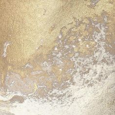 an abstract painting with gold and white colors on the ground, including water droplets in the sand