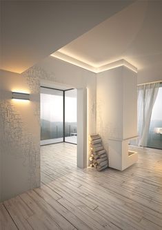 an empty room with white walls and wood flooring is lit by recessed lighting