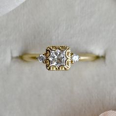 a diamond ring sitting on top of a white cloth