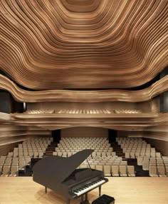 an empty concert hall with a grand piano