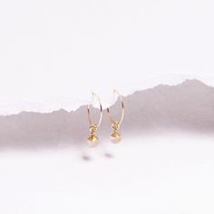 Golden Rutilated Quartz Minimalist Drop Earrings for Her - Gifts under 40 - Mothe's Day - Genuine Quartz Boho style jewelry - Golden crystal Gemstones: 9x6mm approximately Bezel: Vermeil Gold (14k Gold over Sterling Silver) Ear Wires: 14K Gold Filled Wire: 21 gauge / 0.70mm thick Wire Diameter: 15mm Gemstone: Genuine Golden Rutilated Quartz Note that due to the handmade nature of these genuine stones, measurements are approximately and might vary slightly for each stone. Made in the USA.   Je... Minimalist Faceted Drop Earrings, Minimalist Everyday Faceted Earrings, Minimalist Faceted Everyday Earrings, Dainty Faceted Everyday Earrings, Minimalist Gemstone Hoop Earrings For Gift, Golden Crystal, Golden Rutilated Quartz, Boho Style Jewelry, Rutilated Quartz