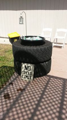 a no speed limit sign sitting on top of a tire