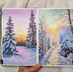 someone is holding up an open book with paintings on it and the pages are covered in snow