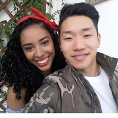 a young man and woman are smiling for the camera while standing next to each other