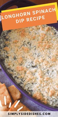 a casserole dish with cheese and spinach dip in it, surrounded by crackers