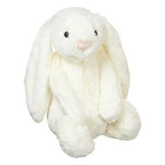 a white stuffed rabbit sitting up against a white background